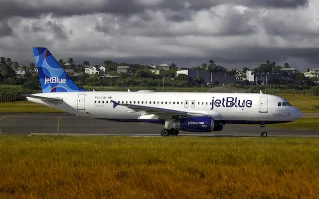 A jetBlue aircraft on a landing strip.