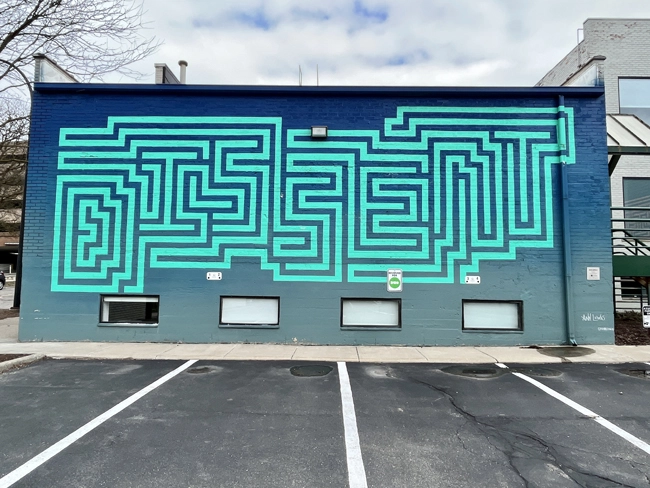 A mural located at 123 N Ashley in the Creative District in downtown Ann Arbor entitled 'May Her Memory Be Our Innermost Revolution' by artist Ann Lewis as part of the A2AC mural tour.