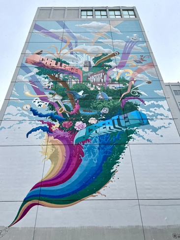 A mural at 100 S Fourth Ave of Courthouse Square entitled 'Challenge Everything. Create Anything' aka Big Wall by artists Mary Thiefels and Danjiel Matanic in downtown Ann Arbor. This mural is part of Treetown Murals.