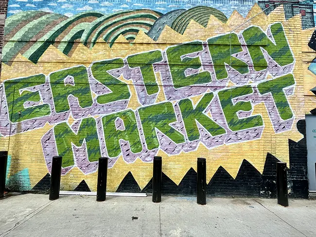 A mural depicting the name of the neighborhood 'Eastern Market' nearby the main market area of Eastern Market in Detroit Michigan