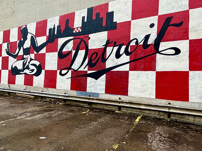 A mural in downtown with the city name and a drawing of the Spirit of Detroit statue.