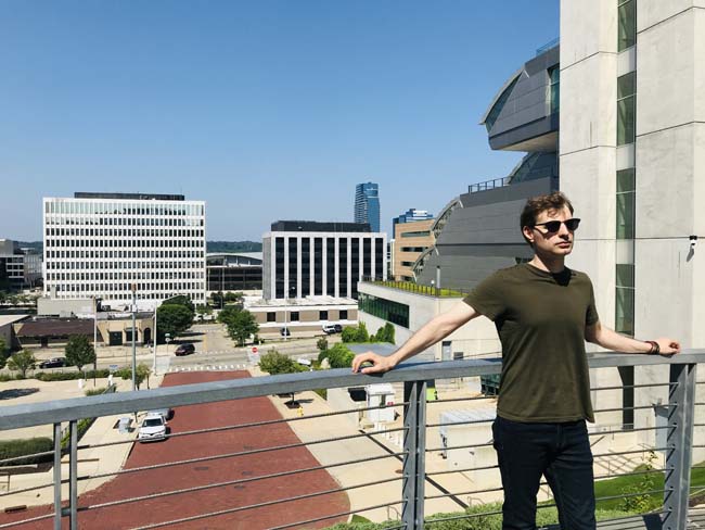 Author stands on a high elevation overlooking the city of Grand Rapids.