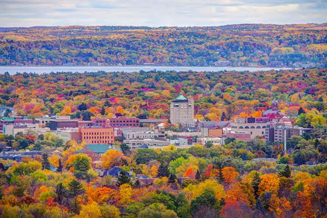 Taken from on top a hill, with colorful autumn trees surrounding Traverse City.