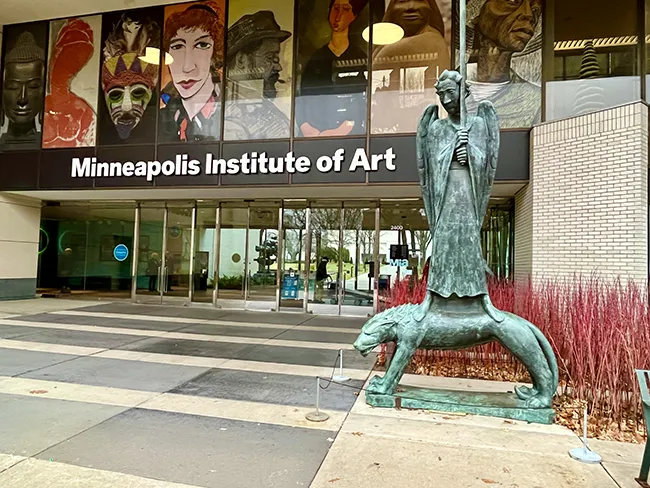 A sculpture stands outside the colorful entrance to the Minneapolis Institute of Art in Minneapolis, MN