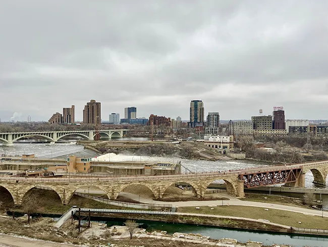 View of the Stone Arch Bridge and the city of Minneapolis from the observation deck of the Mill City Museum.