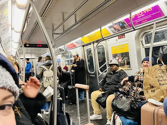 Passengers riding inside a subway cart in Manhattan, New York City.