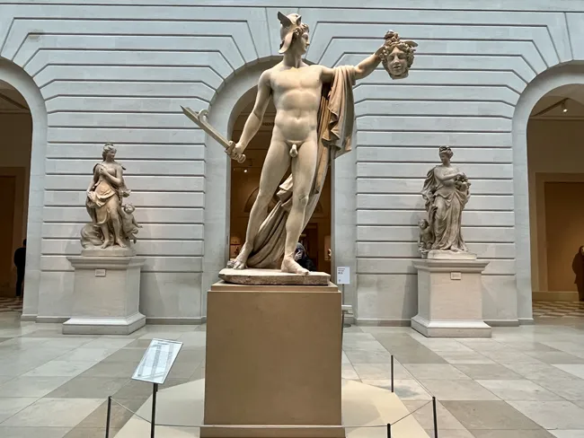 A statue of the Greek mythical character Perseus beheading Medusa in the New York Metropolitan Museum of Art aka The Met.