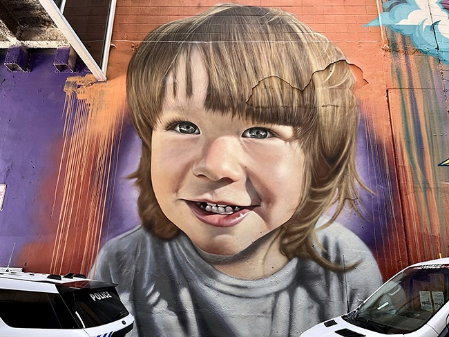 A mural of a small boy in Luminous Lane in uptown Charlotte.