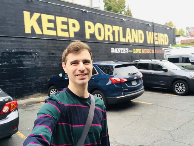 Behind a music venue called Dante's is the iconic 'Keep Portland Weird' mural.